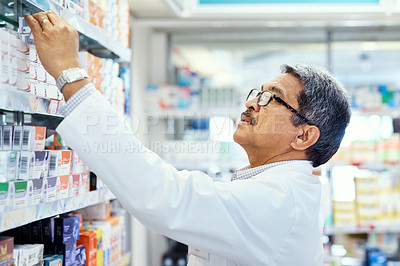 Buy stock photo Shot of a mature pharmacist working in a chemist