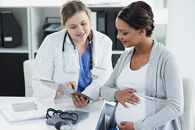 Buy stock photo Talking, results and a doctor with a pregnant woman during a consultation for progress on a baby. Communication, smile and a hospital worker speaking to a patient about healthcare during a pregnancy