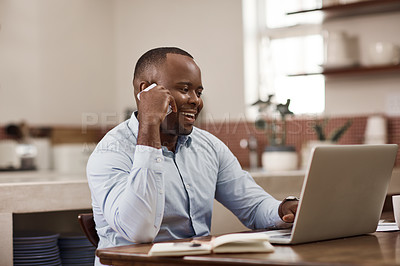 Buy stock photo Cropped shot of a handsome young businessman making a phonecall while working on his laptop at home
