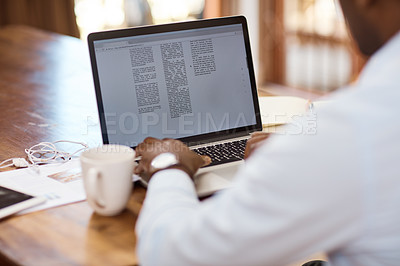 Buy stock photo Rearview shot of an unrecognizable young businessman working on his laptop at home