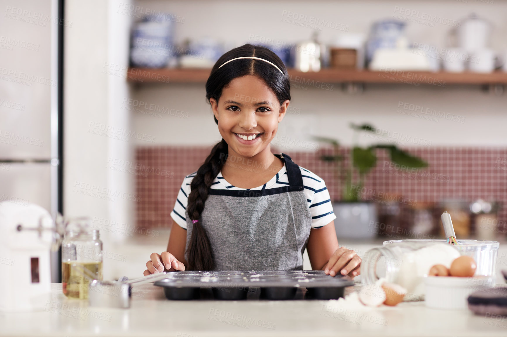 Buy stock photo Cropped shot of an adorable little girl baking in the kitchen at home