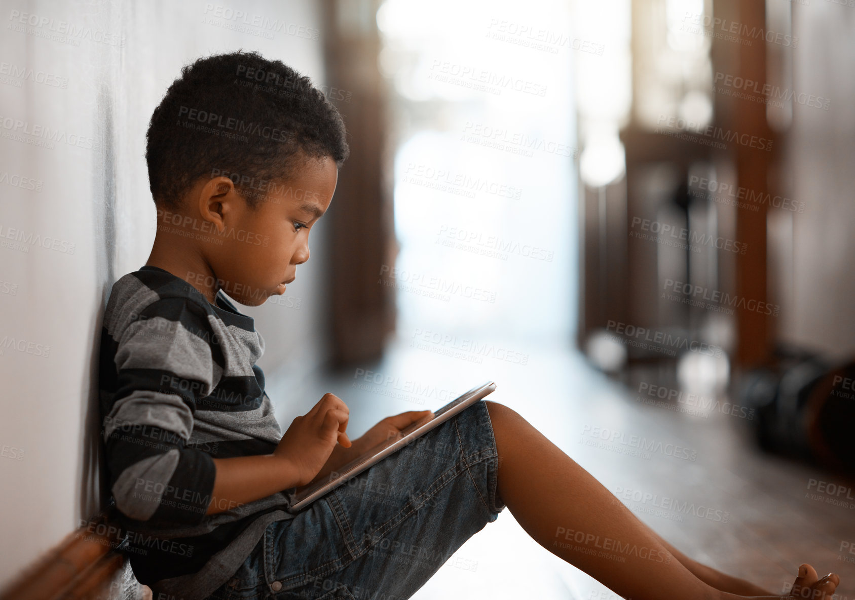 Buy stock photo Relax, tablet and African kid in home on learning app, game or reading story for education online. Digital technology, boy and child with internet addiction, streaming cartoon or watch show in house