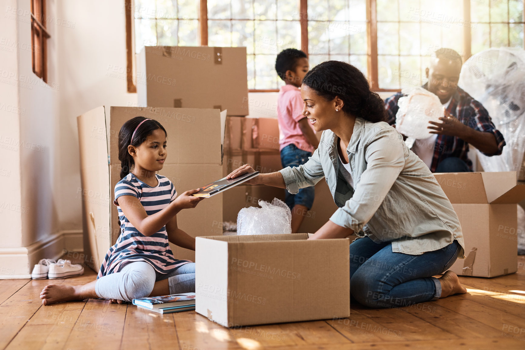 Buy stock photo Shot of a young family moving house