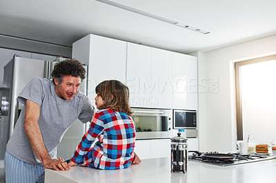 Buy stock photo Cropped shot of a mature father and his young son in the kitchen at home