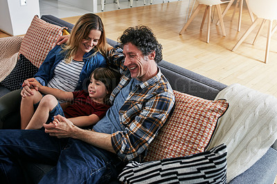 Buy stock photo Mom, dad and child smile on sofa in living room for love, care and fun quality time together in family home. Happy young boy, cute kid and relax with parents in lounge, happiness and bonding on couch