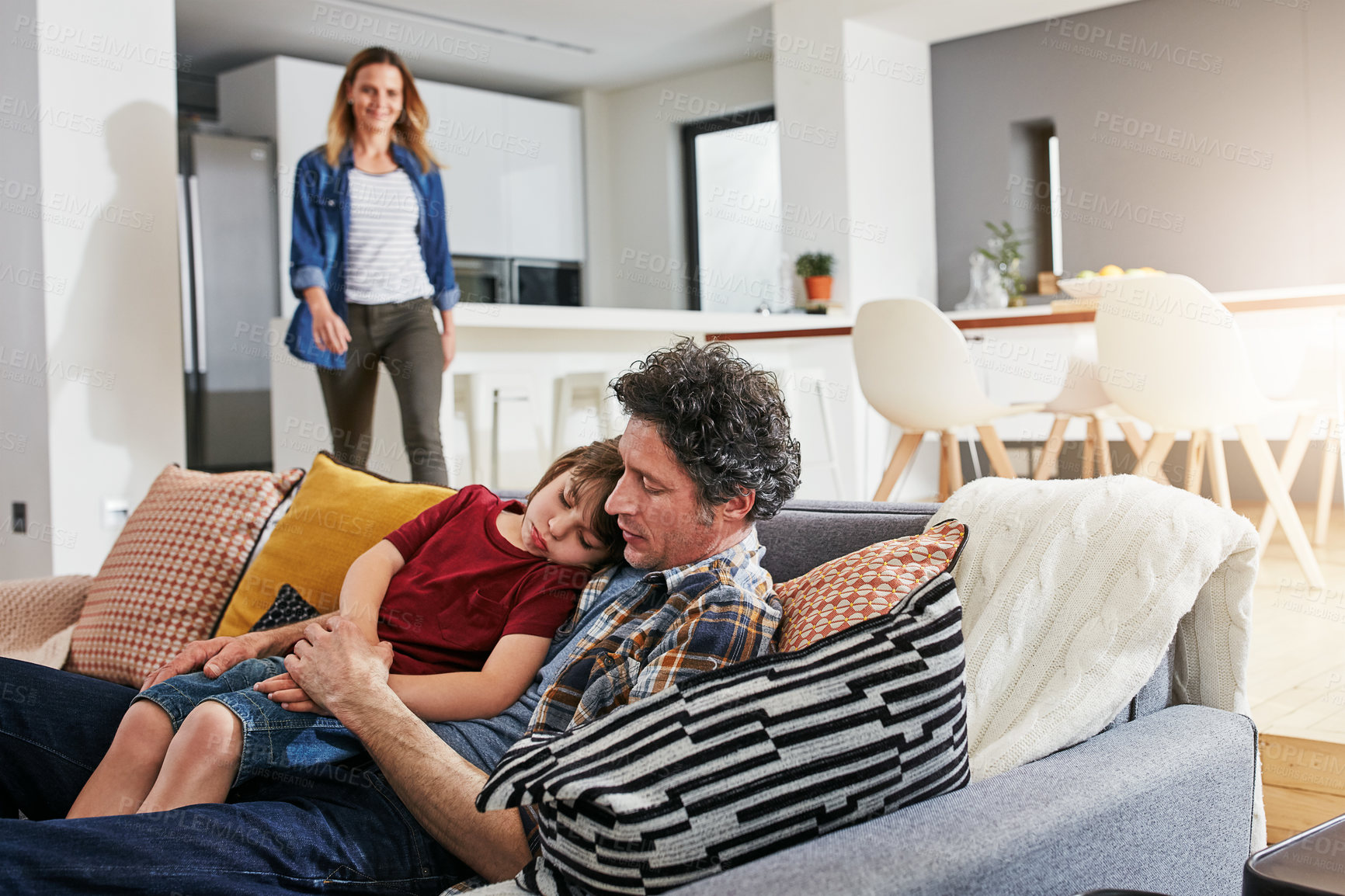 Buy stock photo Boy, sick and hug with dad on couch, home or living room for comfort and support. Illness, sad and unity with mother parent on sofa with father person, fever or care with love for tired kid in lounge