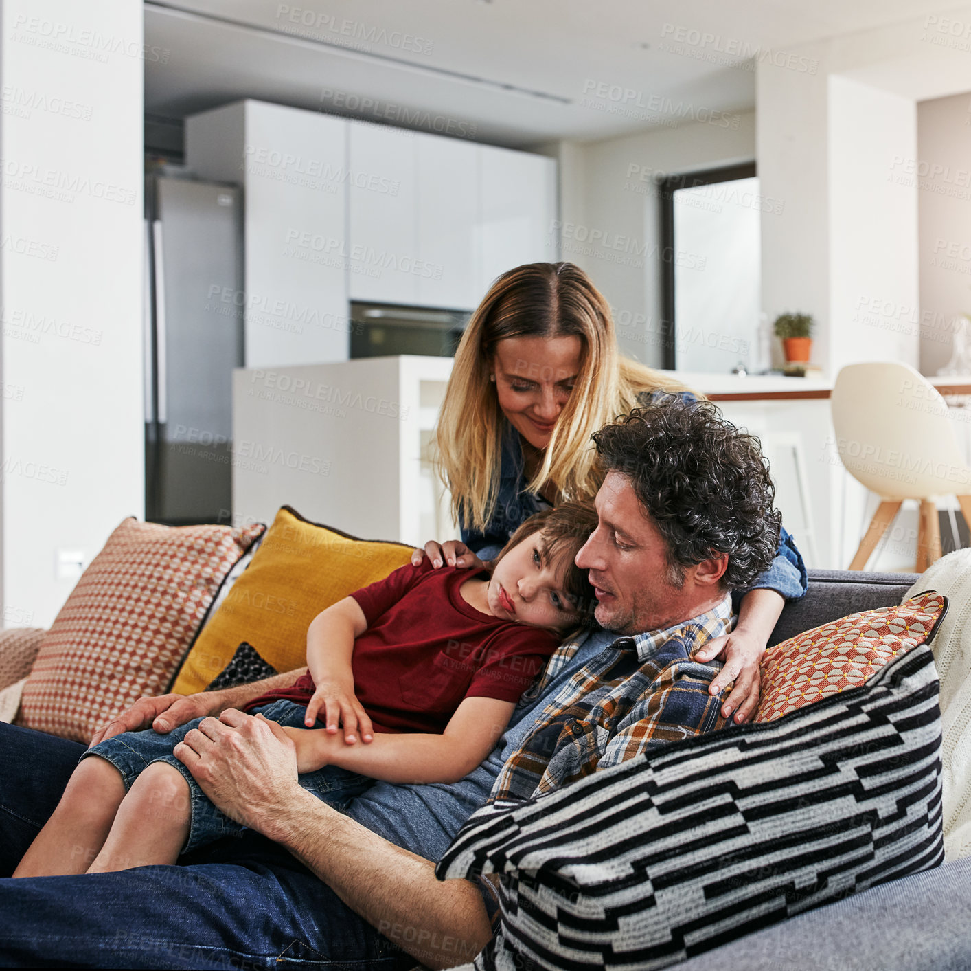 Buy stock photo Boy, sick and hug with dad on sofa, mom and living room for comfort and support in home. Illness, sad and unity with mother parent on couch with father person, fever or care for love anr tired kid