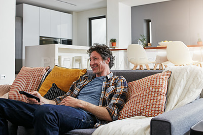 Buy stock photo Cropped shot of a handsome mature man relaxing on the sofa at home
