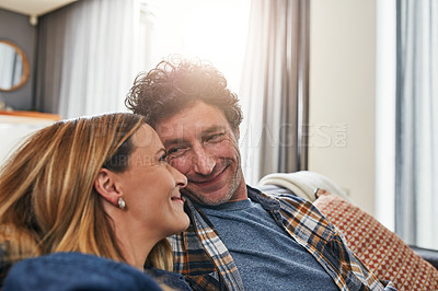 Buy stock photo Face of couple, smile and relax in living room for quality time, love and care of support together at home. Happy man, mature woman and bonding on sofa for break, happiness or loyalty to life partner