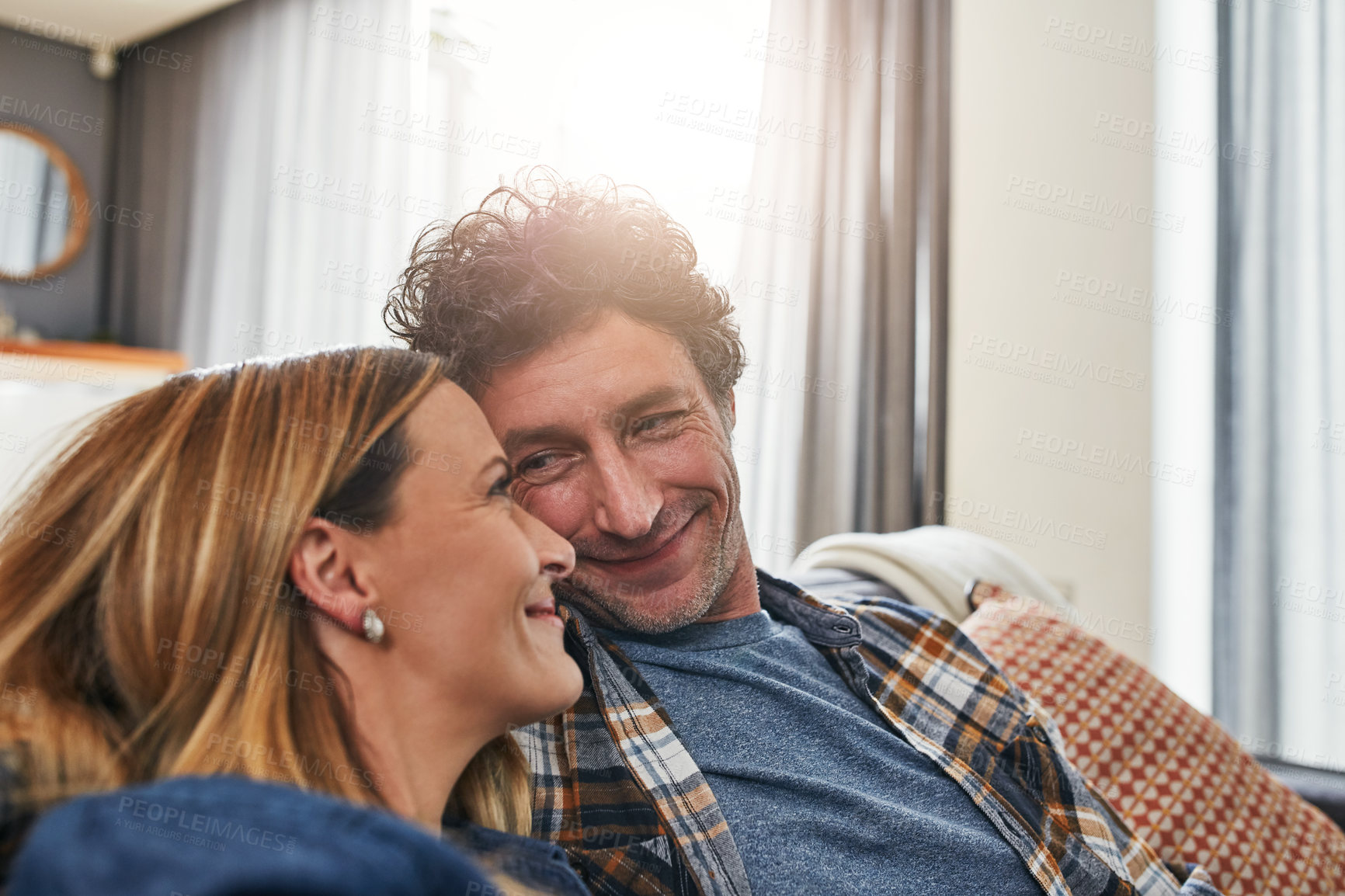 Buy stock photo Face of couple, smile and relax in living room for quality time, love and care of support together at home. Happy man, mature woman and bonding on sofa for break, happiness or loyalty to life partner