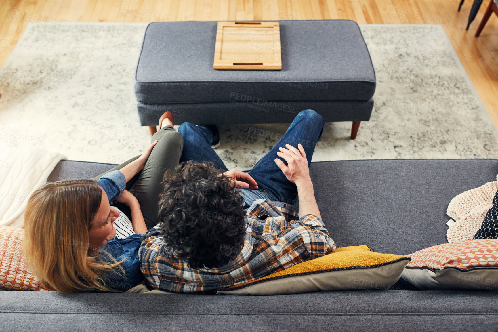 Buy stock photo Top view, couple and relax on sofa in living room for quality time, love and care of conversation, communication or chat. Happy man, woman and talking on couch for break, bonding and together at home
