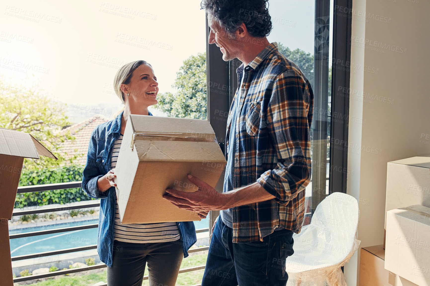 Buy stock photo New home, real estate and couple with boxes, funny and moving in for property investment. Laughing, smile and mature man with woman, mortgage and rental apartment with cardboard package or relocation