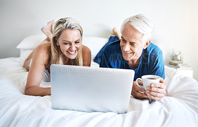 Buy stock photo Happy couple, love or laptop in bed for movie choice and streaming option online on sofa in home. Relax, mature and people in bedroom to chill on social media app on digital website or technology