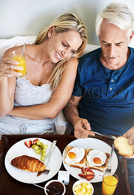 Buy stock photo Couple, eating and tray with breakfast in bed for healthy diet, meal and nutrition in morning. Happy, woman and man with food on plate at hotel for honeymoon hospitality, and room service