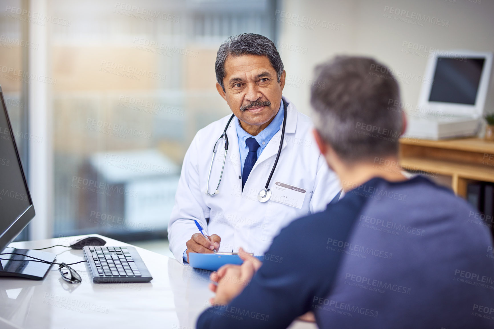Buy stock photo Healthcare, consultation and male doctor talking to a patient about a diagnosis in the clinic. Professional, discussion and mature medical worker in discussion with a man in the medicare hospital.
