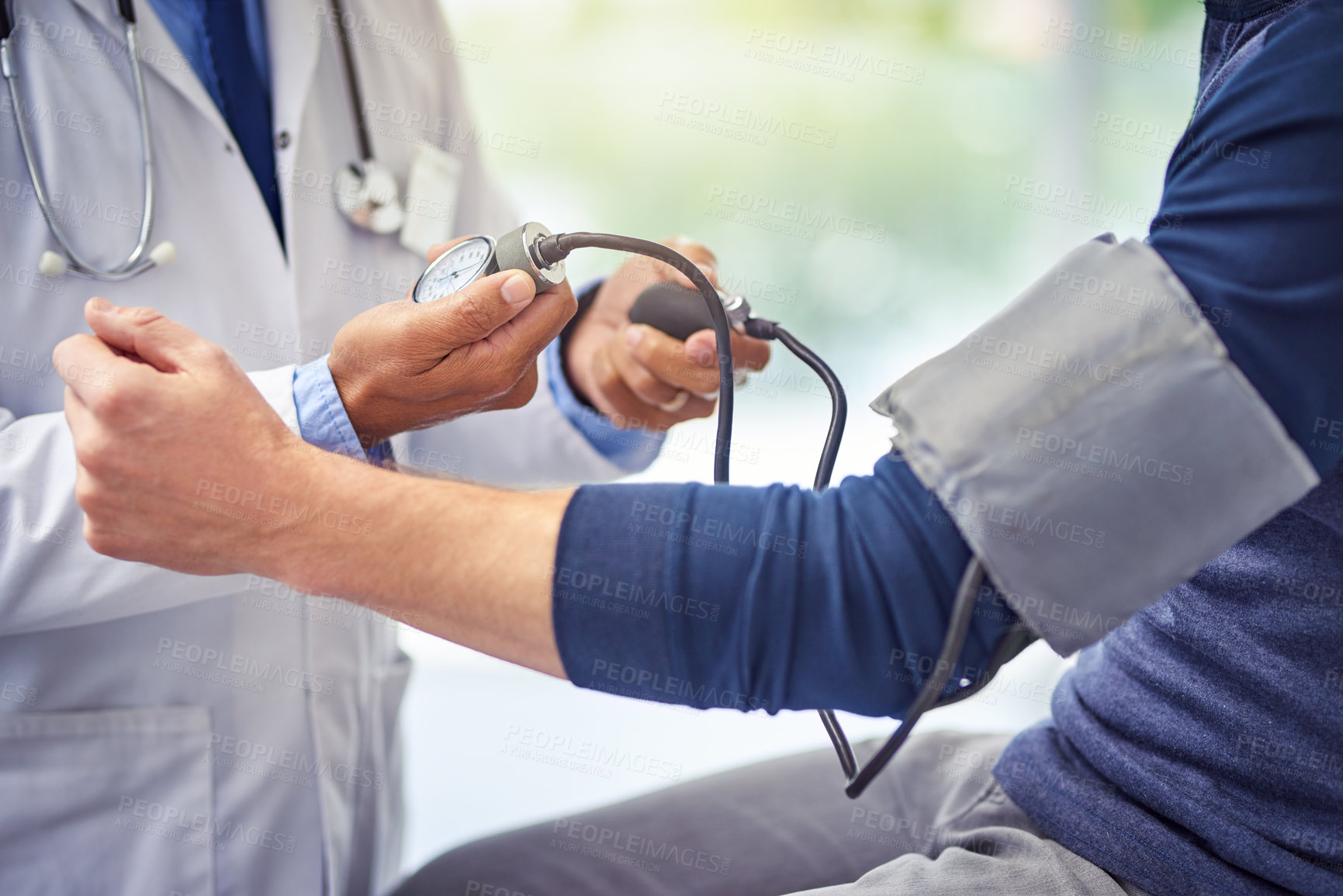 Buy stock photo Check up, doctor and man patient for blood pressure test at a hospital with lens flare. Consultant or medical workers,  health wellness and nurse with male person for healthcare exam at a clinic