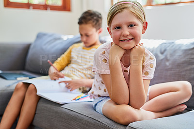Buy stock photo Cropped shot an adorable brother and sister doing schoolwork on the sofa at home