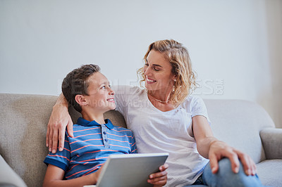 Buy stock photo Cropped shot of a mother and her son using a laptop together on the sofa at home