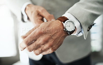 Buy stock photo Closeup of an unrecognizable businessman attaching a watch to his wrist at home during the day