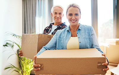 Buy stock photo Portrait of a happy mature couple carrying boxes on moving day