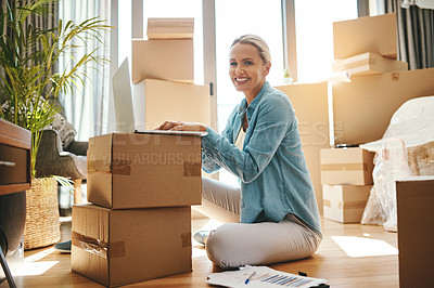 Buy stock photo Portrait of a mature woman using a laptop on moving day