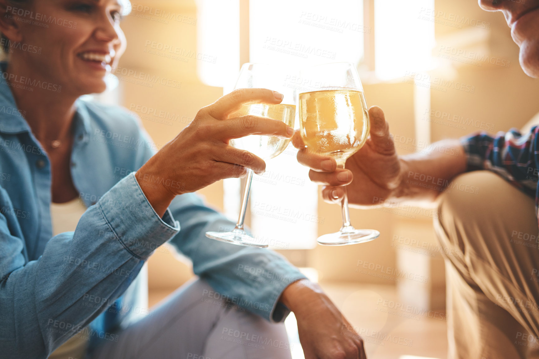 Buy stock photo Shot of a happy mature couple toasting with wine on moving day