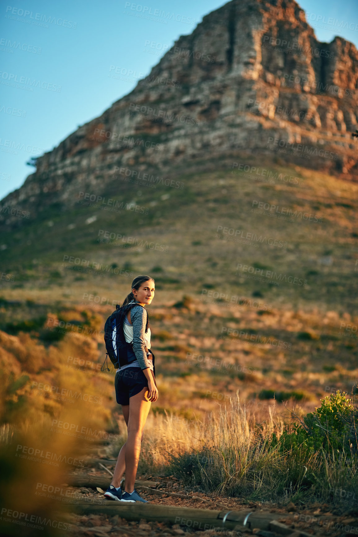 Buy stock photo Portrait of a young woman out on a hike through the mountains