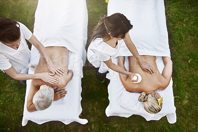 Buy stock photo High angle shot of a middle aged couple having a relaxing massage together at a spa during the day