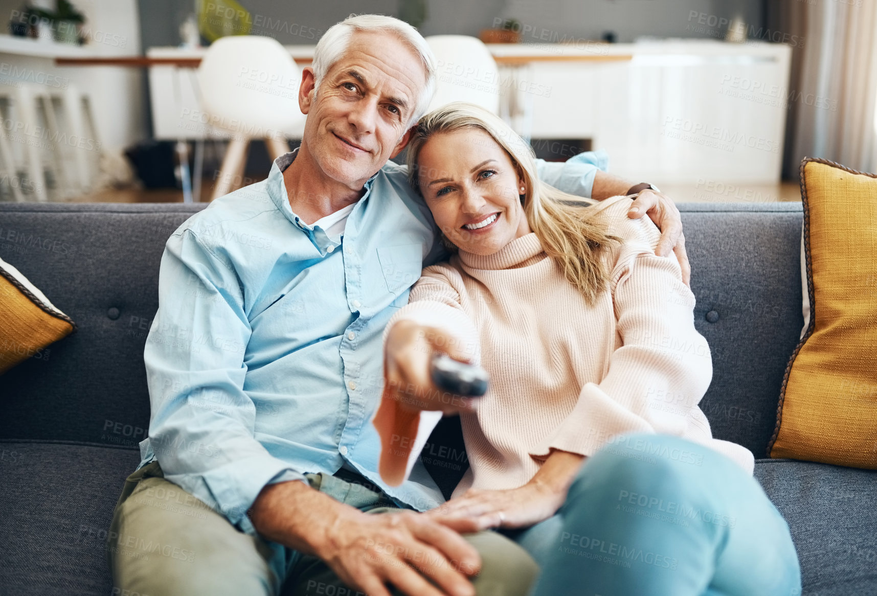 Buy stock photo Cropped shot of an affectionate mature couple relaxing on the sofa at home