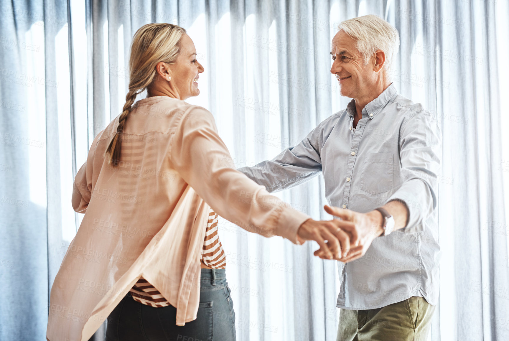 Buy stock photo Cropped shot of an affectionate mature couple dancing in their home