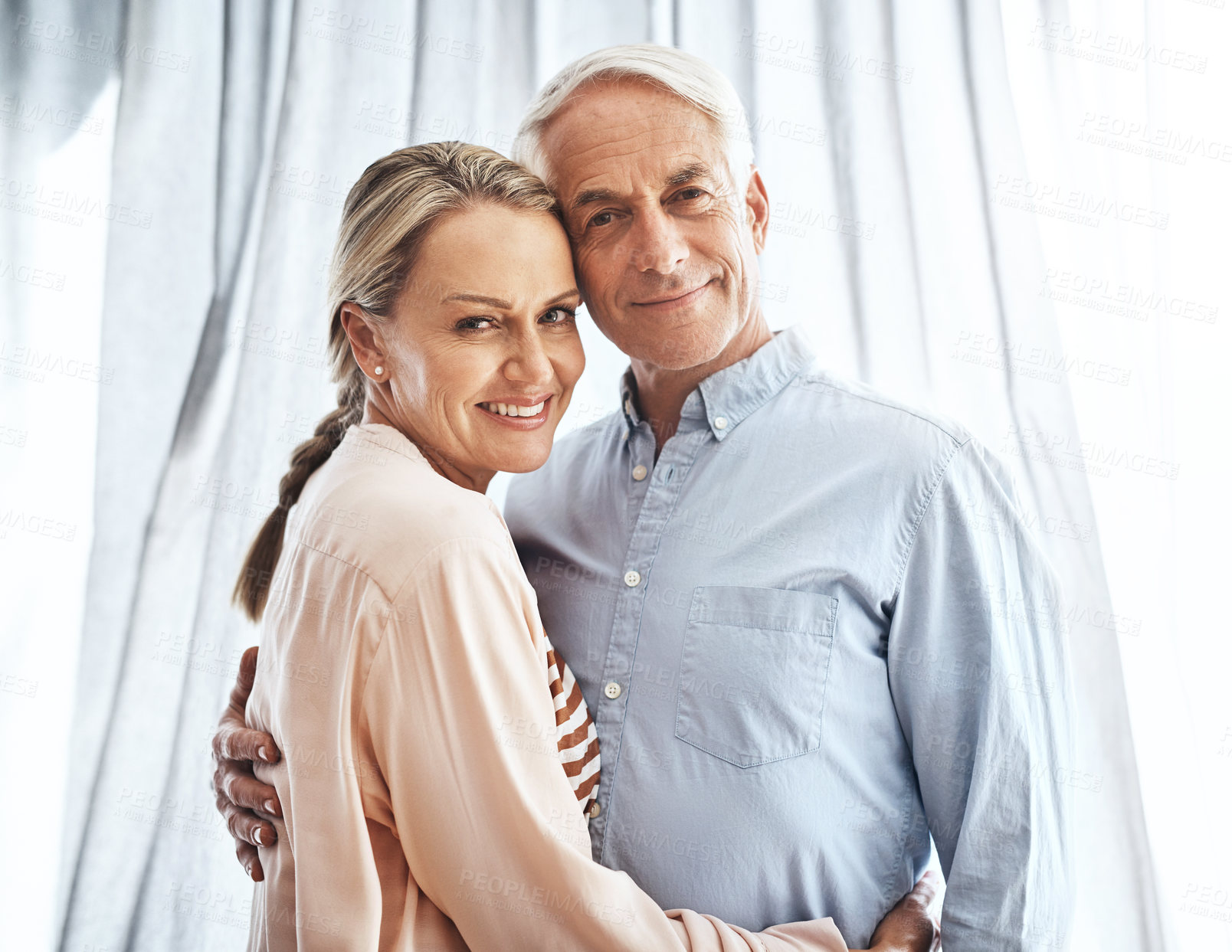 Buy stock photo Mature couple, portrait and embrace in home for bonding, relationship and support together with romance. Happy people, face and hug in apartment for anniversary, marriage and trust with partner love