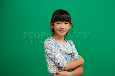 Buy stock photo Happy, arms crossed and portrait of Asian girl in studio for smile, fashion and youth. Happiness, casual and cute with young child isolated on green background for mockup student and confidence