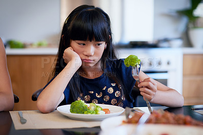 Buy stock photo Shot of a little girl refusing to eat her broccoli