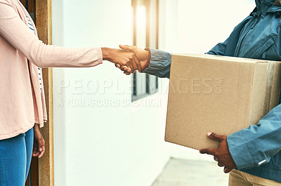 Buy stock photo Closeup shot of a courier shaking hands with a customer while making a delivery