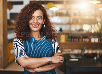 Buy stock photo Cropped portrait of an attractive young woman standing with her arms folded in her coffee shop