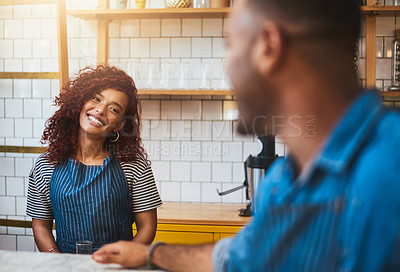 Buy stock photo Cropped shot of an attractive young woman talking to a male colleague in their coffee shop