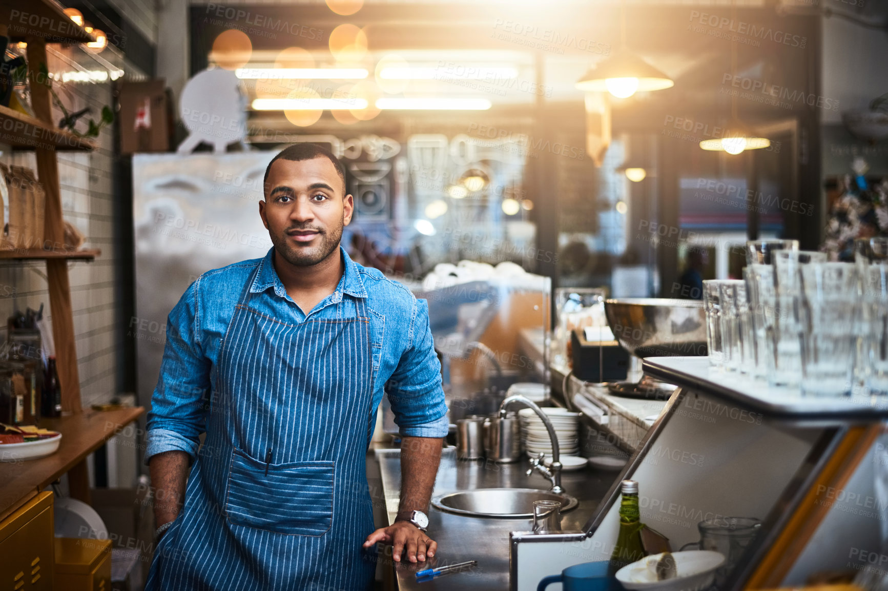 Buy stock photo Coffee shop, barista and portrait of man in restaurant for service, working and standing by cafe counter. Small business owner, bistro startup and serious male waiter in cafeteria ready to serve