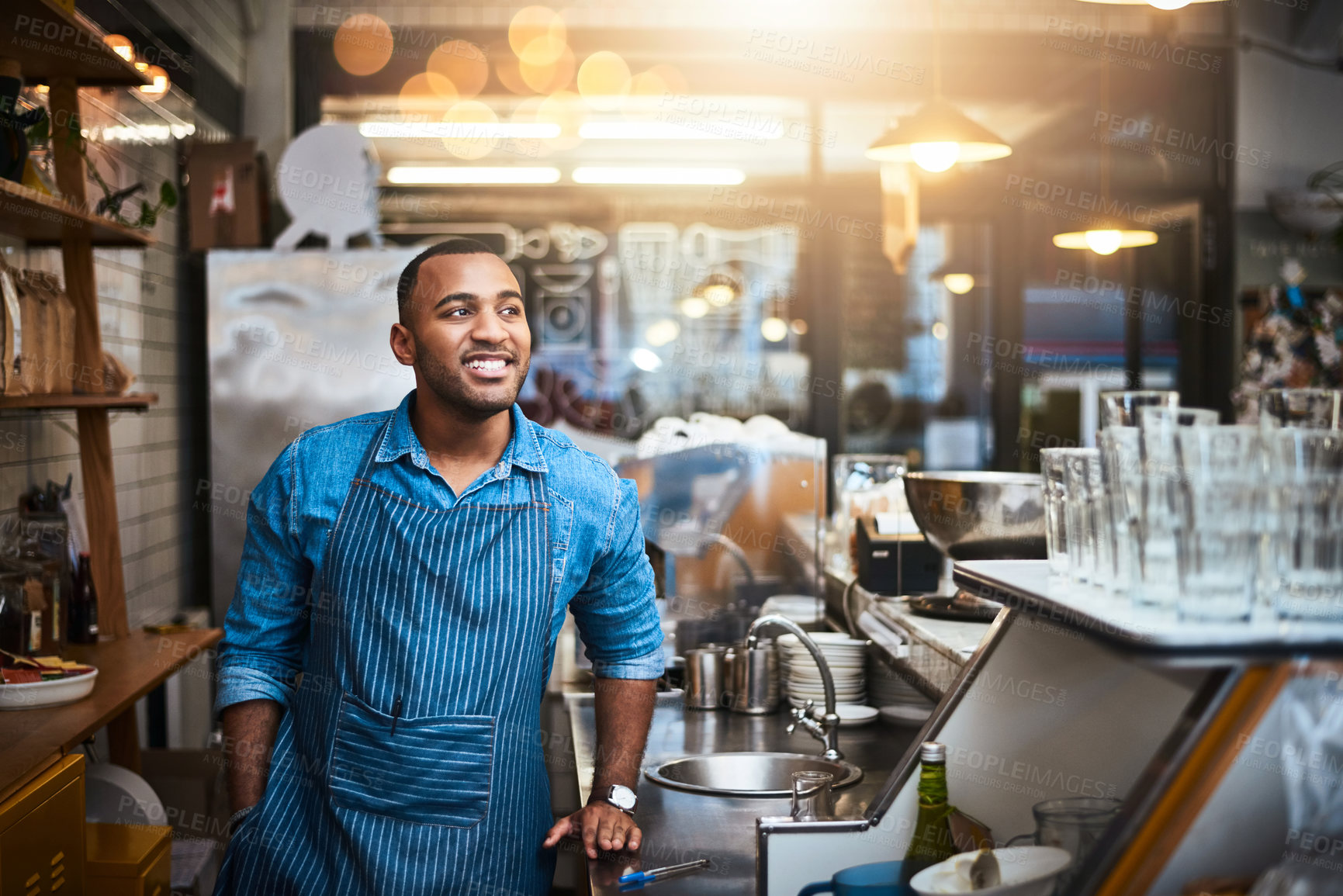 Buy stock photo Coffee shop, barista and happy black man in restaurant for service, working and thinking in cafe. Small business owner, bistro startup and male entrepreneur smile in cafeteria counter ready to serve