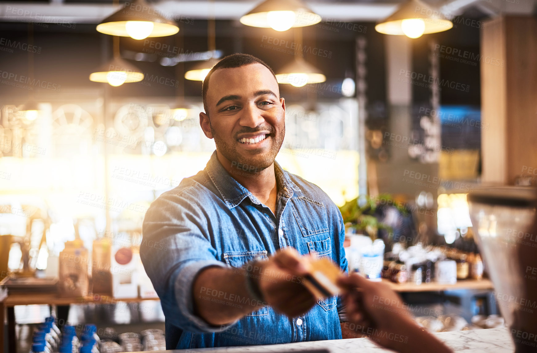 Buy stock photo Shot of a customer making a credit card payment in a cafe