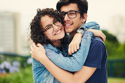 Buy stock photo Portrait of a teenage couple embracing each other outdoors