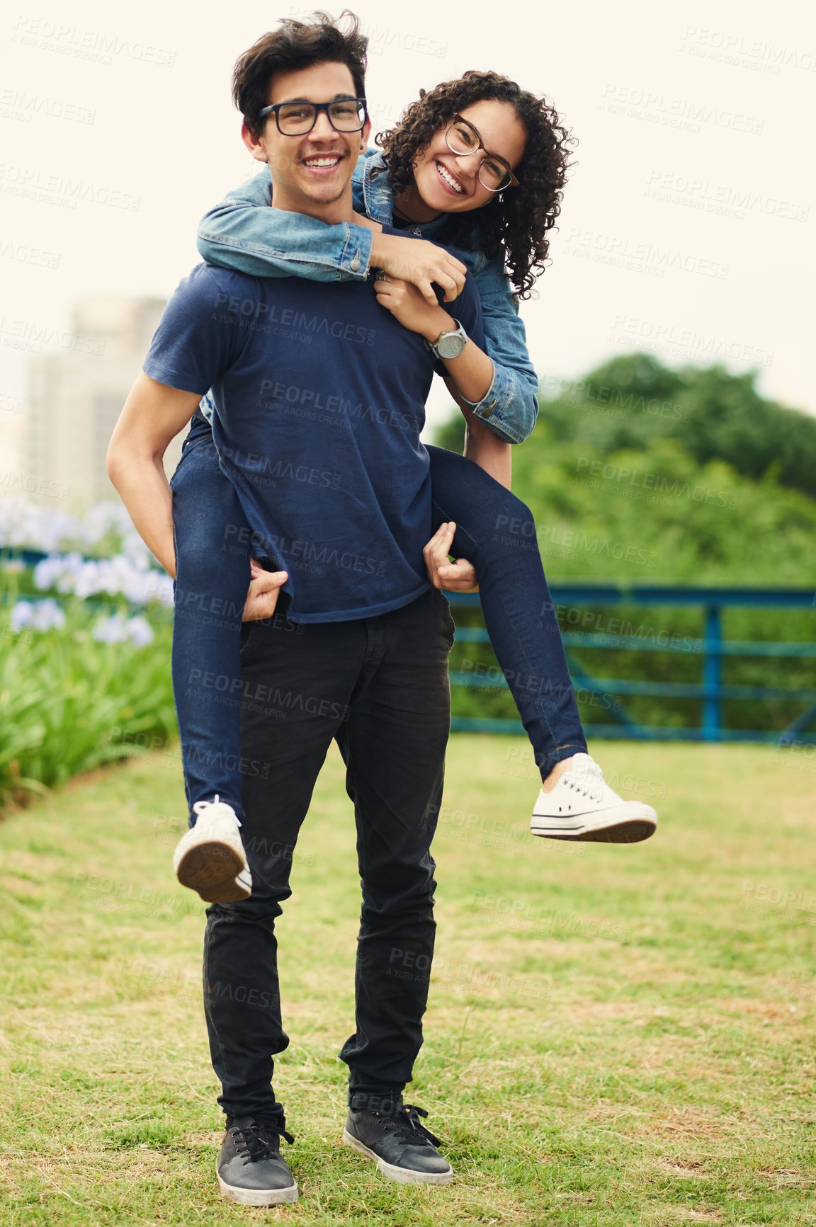 Buy stock photo Couple, piggyback and outdoor with love for portrait, trust and support in loyal relationship. Happy man, woman and carry in park with glasses, milestone celebration and excited for holiday travel