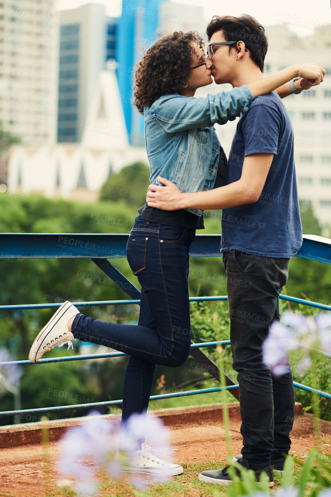 Buy stock photo Shot of a teenage couple kissing outdoors