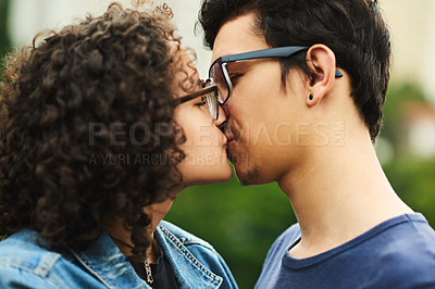 Buy stock photo Cropped shot of a teenage couple kissing outdoors