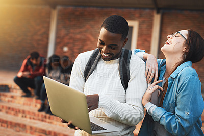 Buy stock photo Shot of a young man and woman using a laptop together on campus