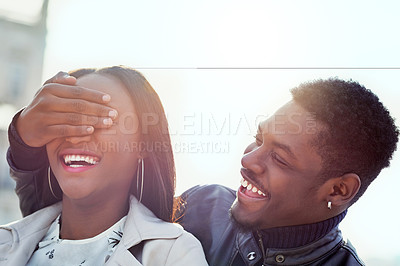 Buy stock photo Shot of a young man covering his girlfriend's eyes outdoors