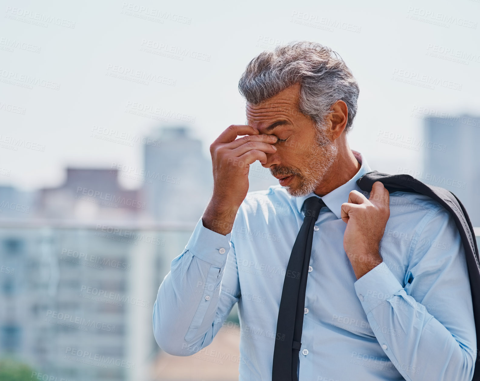 Buy stock photo Cropped shot of a mature corporate businessman experiencing a headache outside