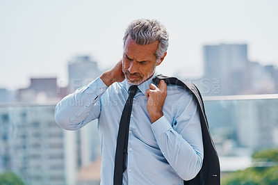 Buy stock photo Cropped shot of a mature corporate businessman experiencing body discomfort outside