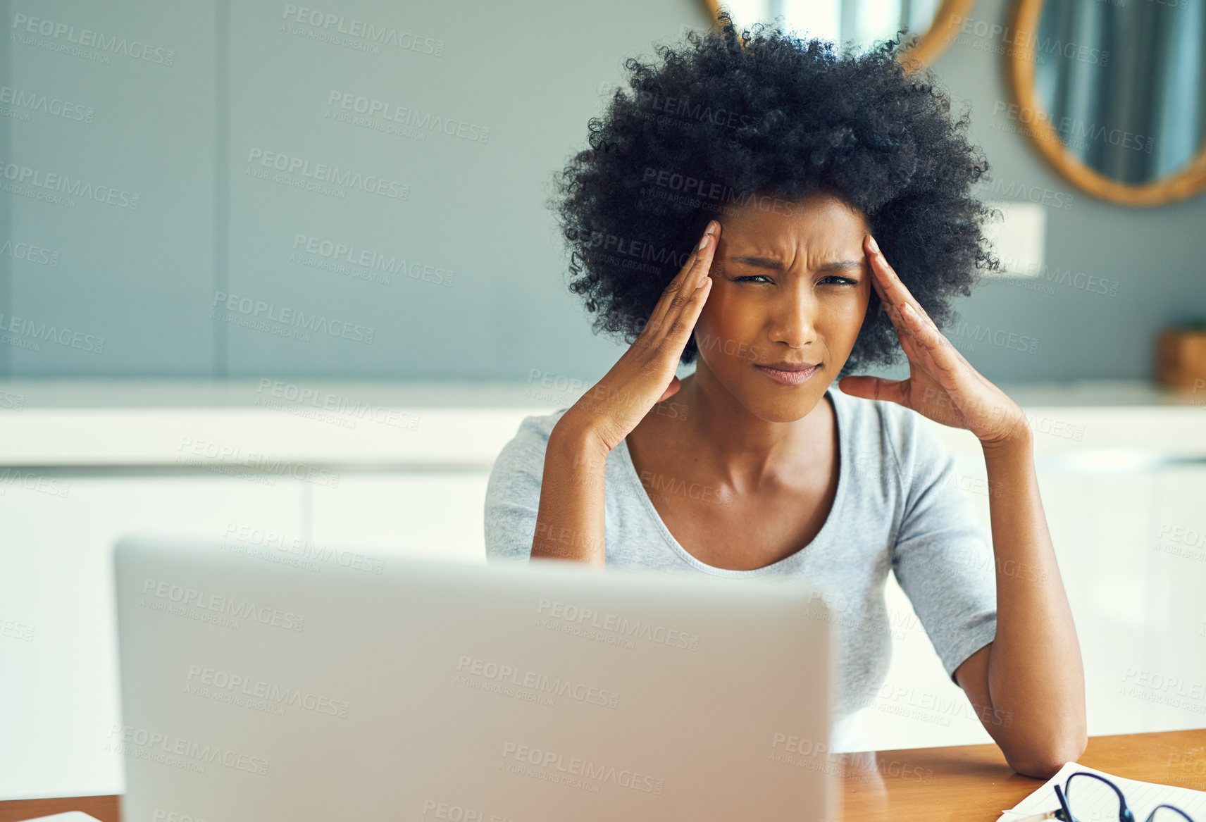 Buy stock photo Cropped portrait of a young businesswoman looking stressed while working at home