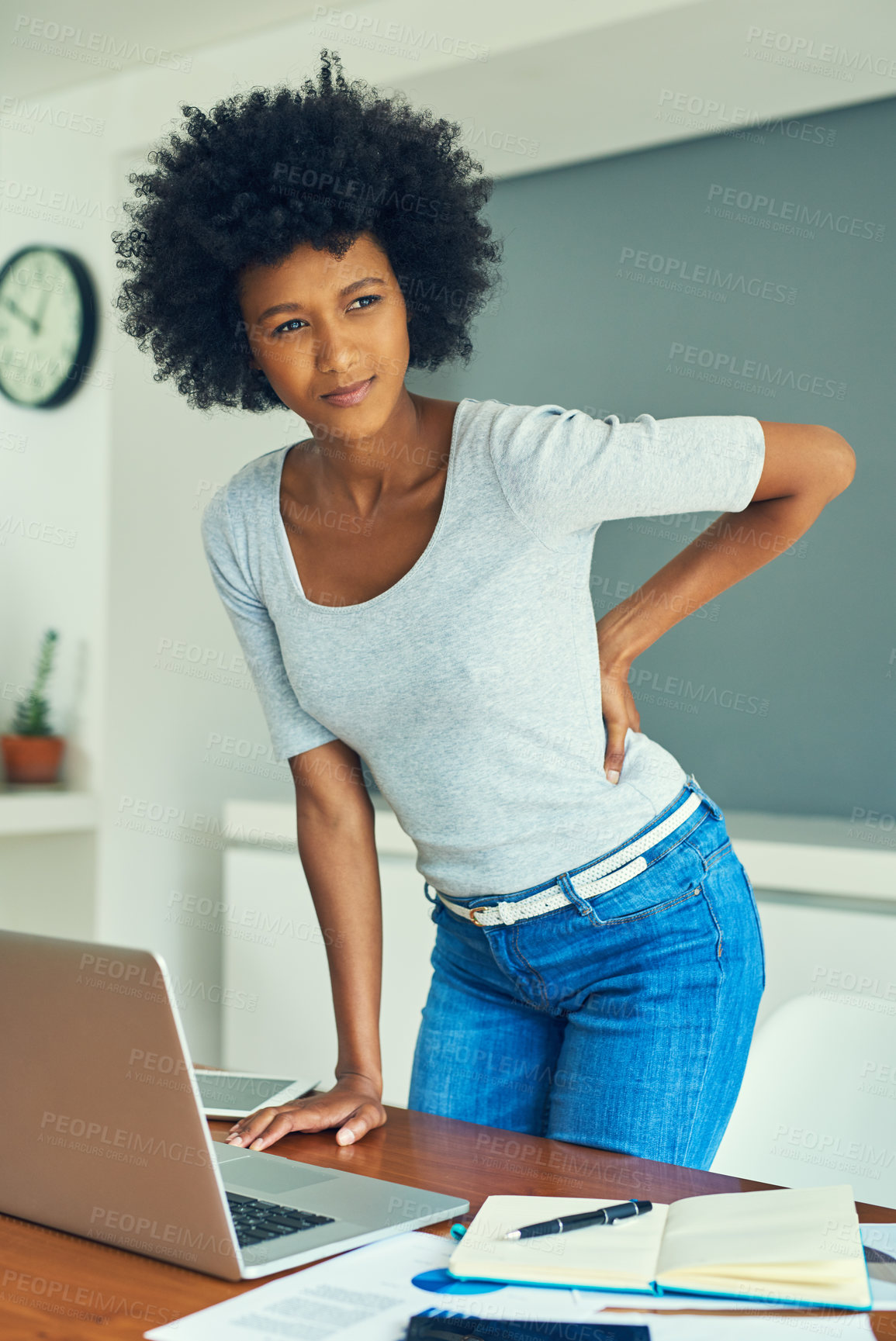 Buy stock photo Cropped shot of an attractive young businesswoman suffering from back pain while working at home