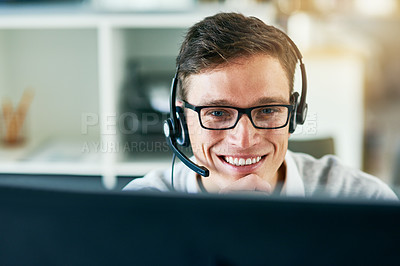 Buy stock photo Shot of a young call center agent working in an office